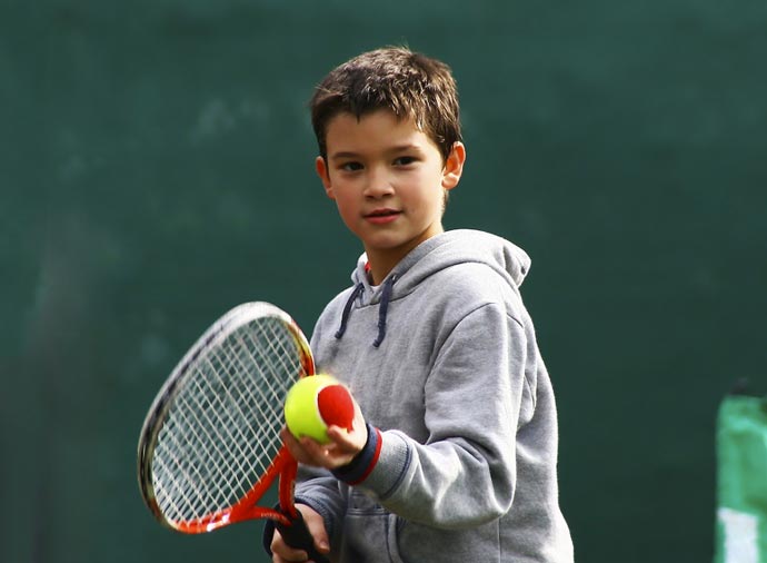 Young child holding a tennis racquet